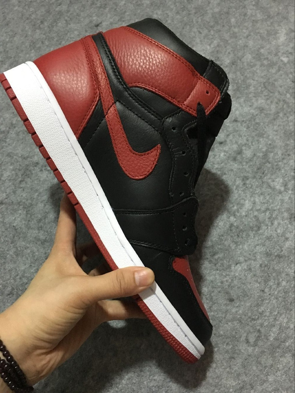 Air Jordan 1 High Sneakers in Black and Red - product image from the listing.