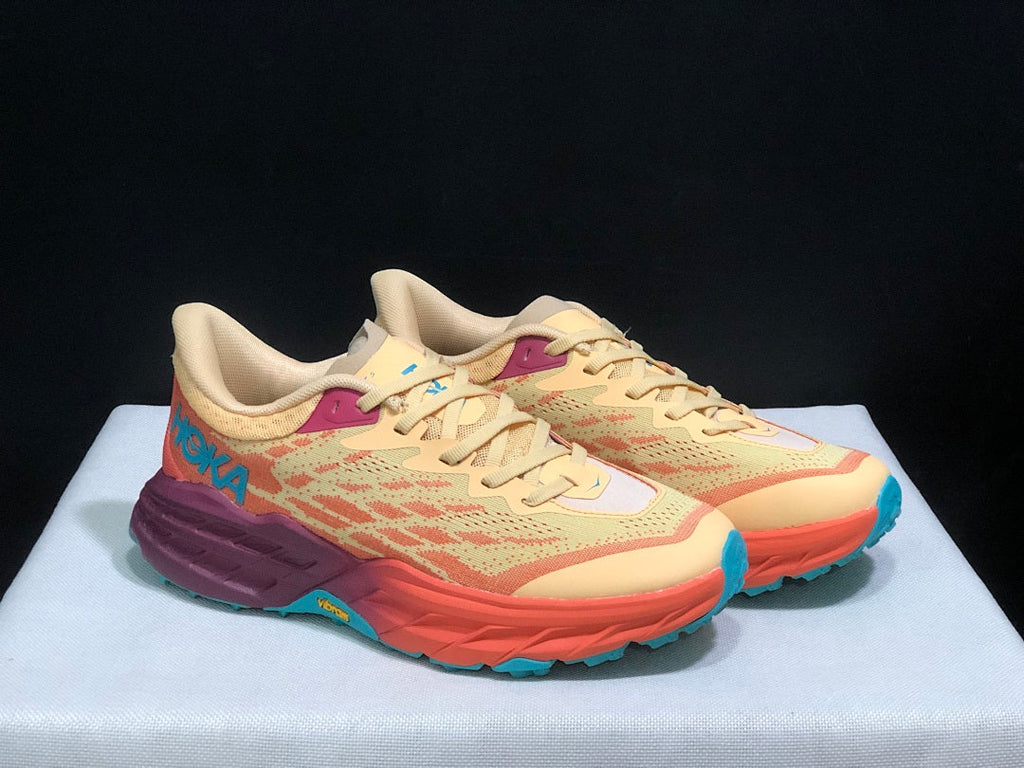 Yellow and Coral HOKA Speedgoat 5 Trail Running Shoes - product image from the listing.