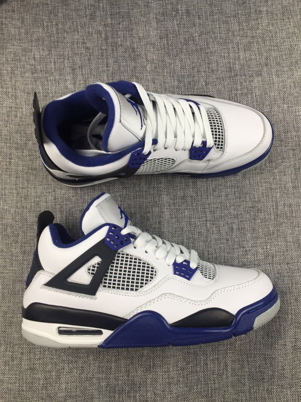 Air Jordan 4 Sneakers in White, Black and Blue - product image from the listing.