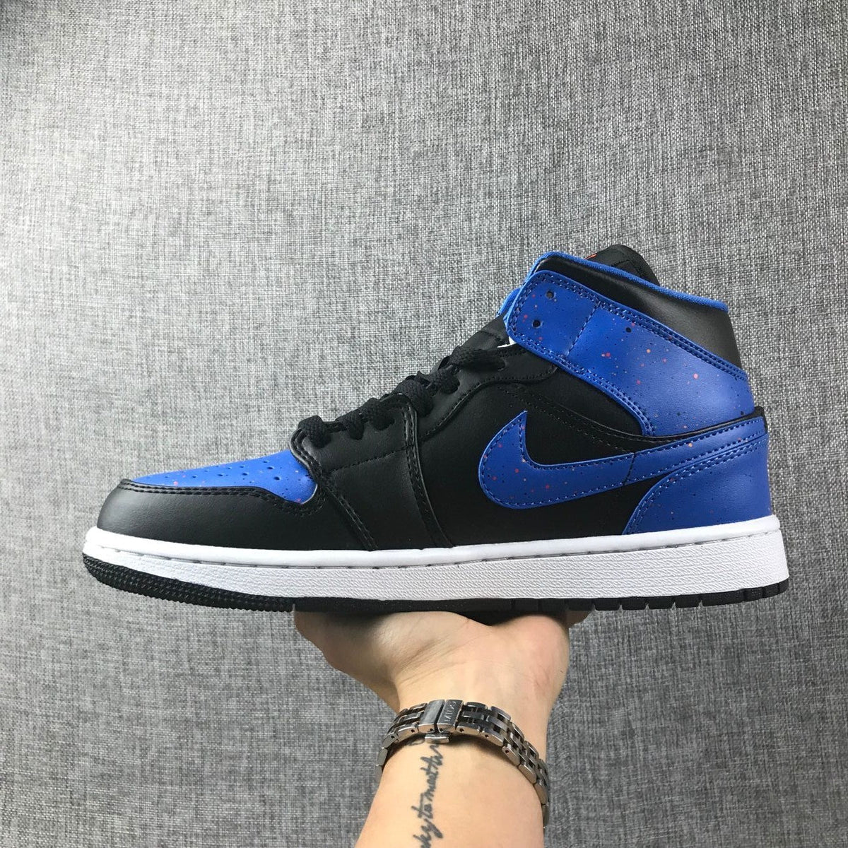 Air Jordan 1 Mid High-Top Sneakers in Black and Blue - product image from the listing.