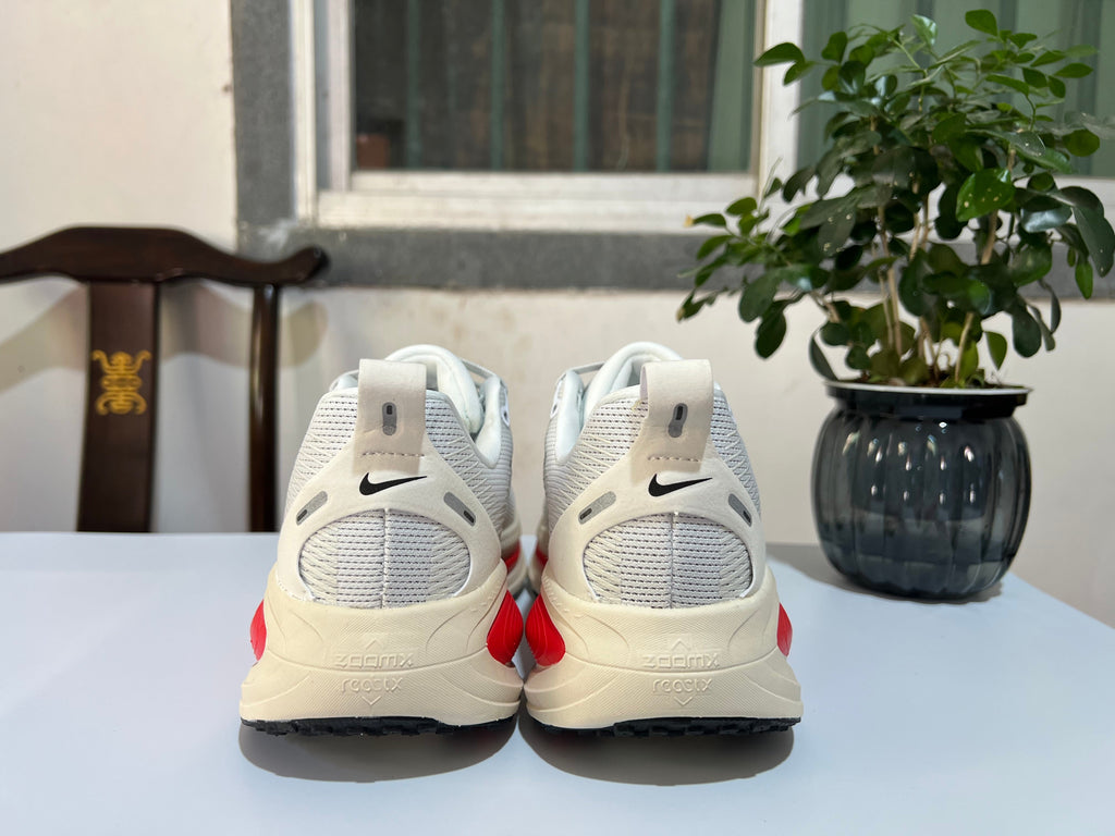 Nike Vomero 18 Running Shoes in White and Red - product image from the listing.