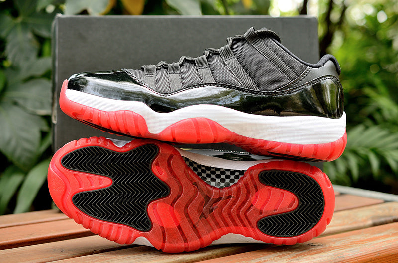 Air Jordan 11 Retro Low Black and Red Sneakers - product image from the listing.