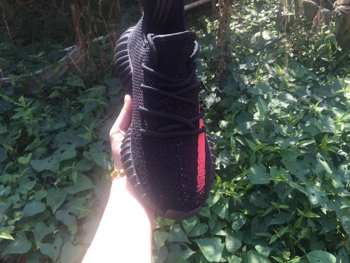 Yeezy Boost 350 V2 Sneakers in Black and Bright Coral - product image from the listing.