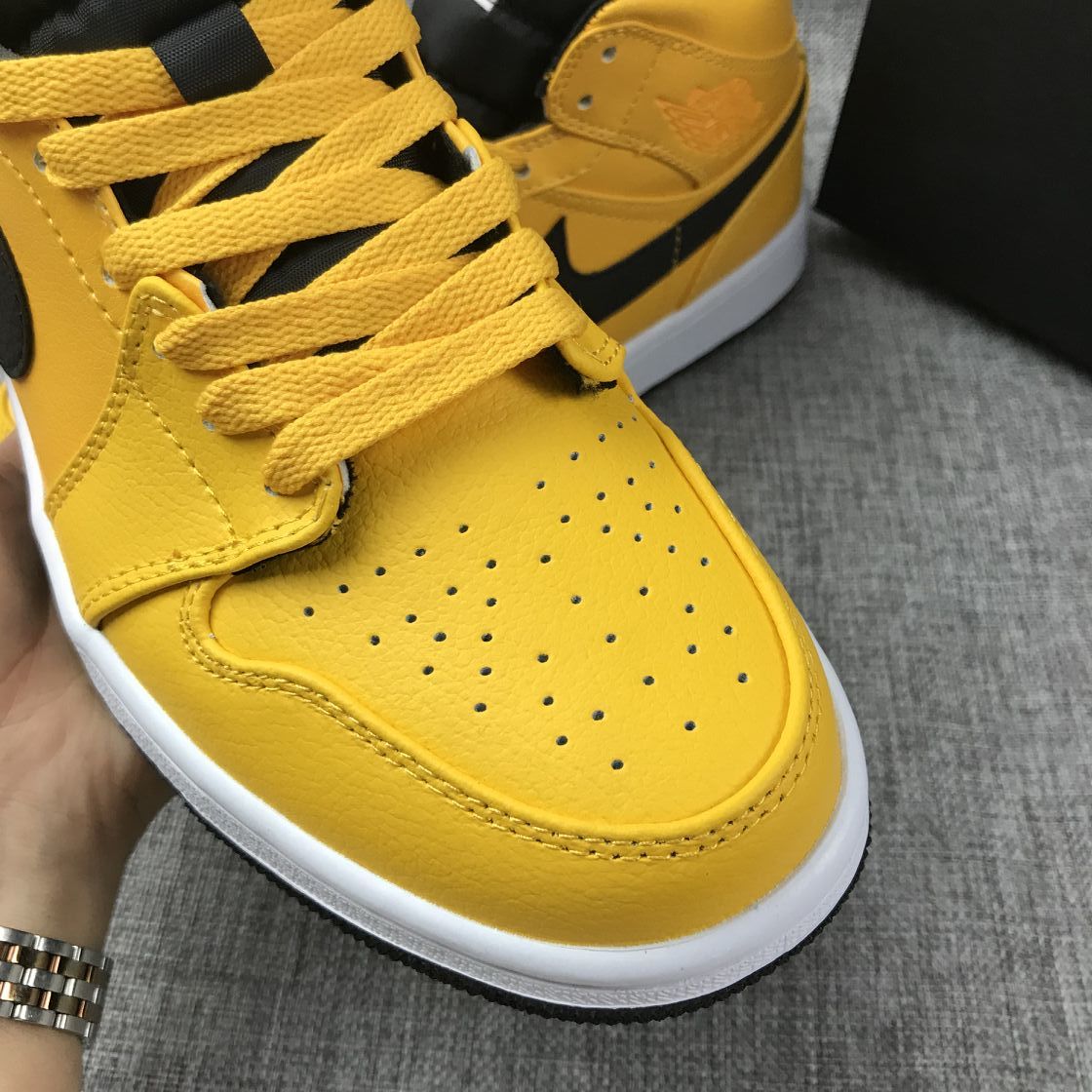 Air Jordan 1 Mid Sneakers in University Gold Black White - product image from the listing.