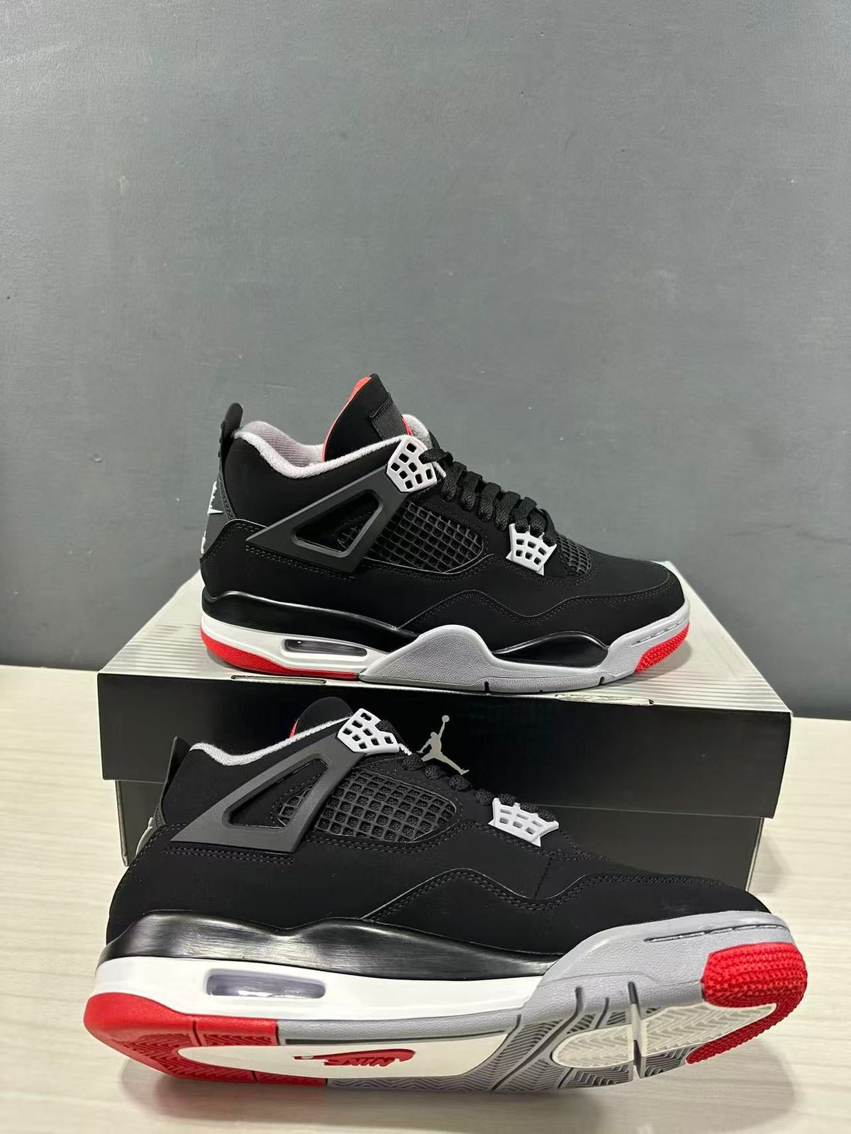 Air Jordan 4 Retro Bred Black Red Sneakers IX8180-001 - product image from the listing.