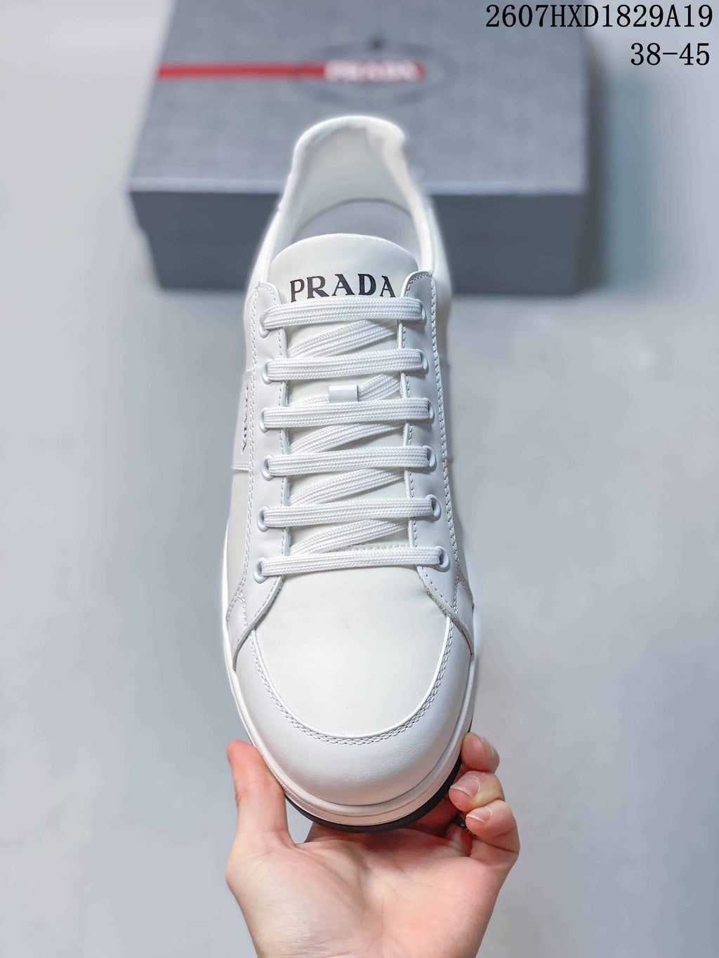 Prada Downtown Low-Top Sneakers in White Leather 2607HXD1829A19 - product image from the listing.