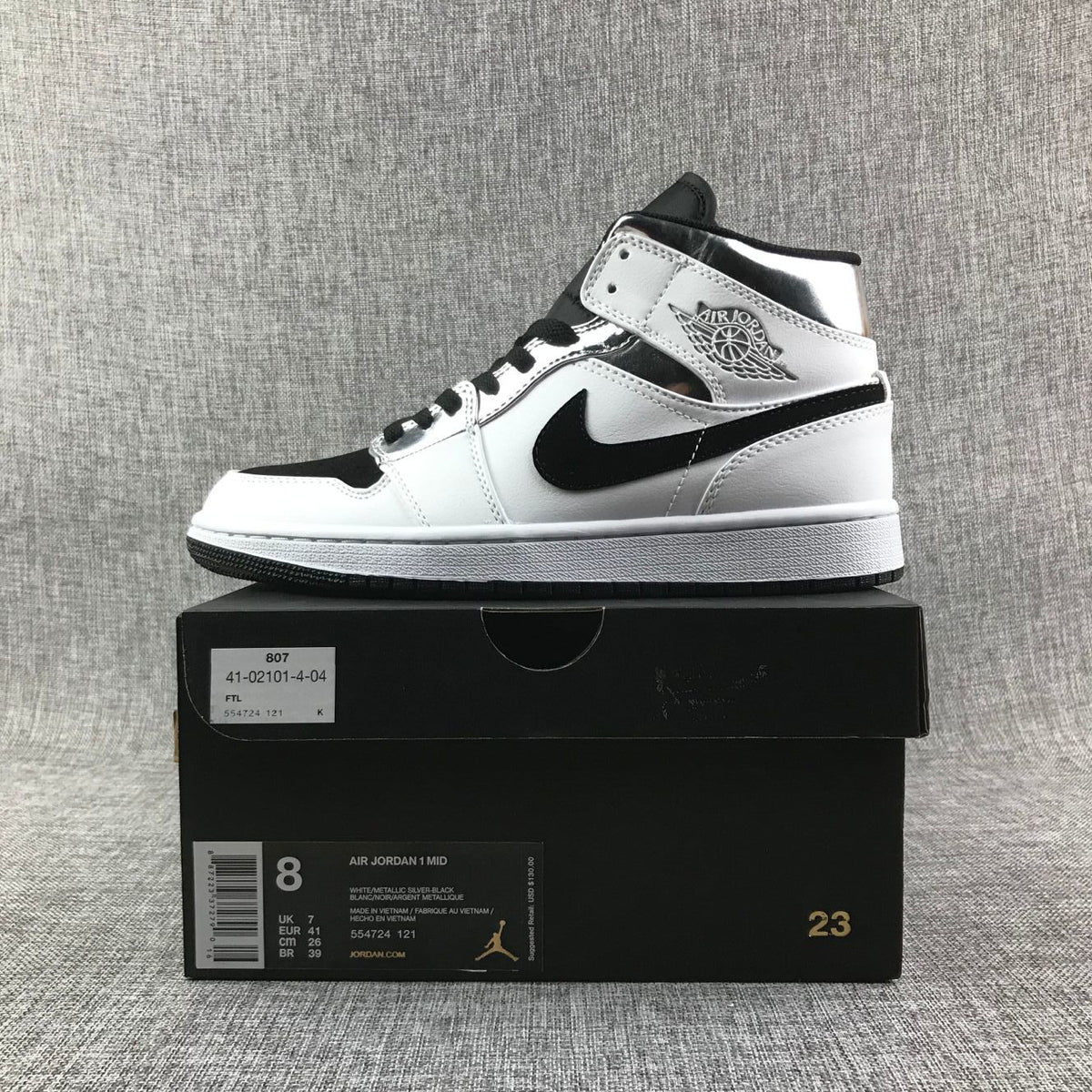 Air Jordan 1 Mid Sneakers in White and Black - product image from the listing.