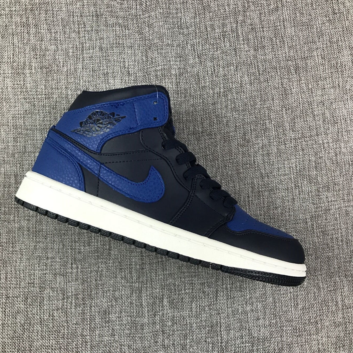 Air Jordan 1 Mid High-Top Sneakers in Black and Royal Blue - product image from the listing.