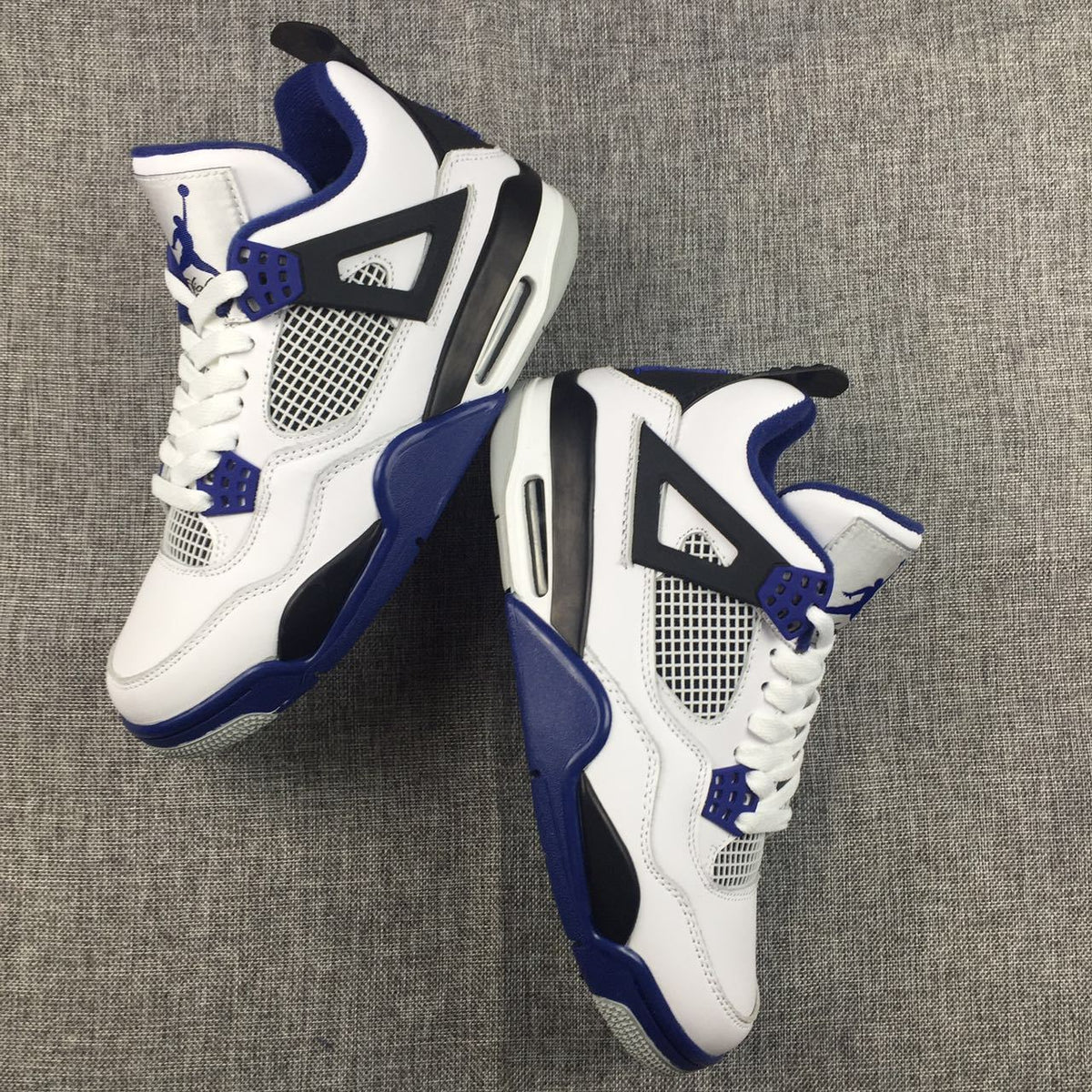 Air Jordan 4 Sneakers in White, Black and Blue - product image from the listing.