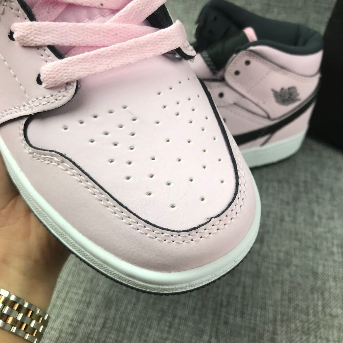 Air Jordan 1 Mid High-Top Sneakers in Pink and Black - product image from the listing.