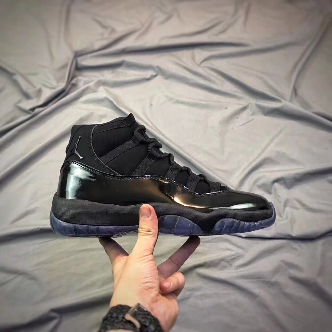Air Jordan 11 Cap and Gown High-Top Sneakers in Black - product image from the listing.