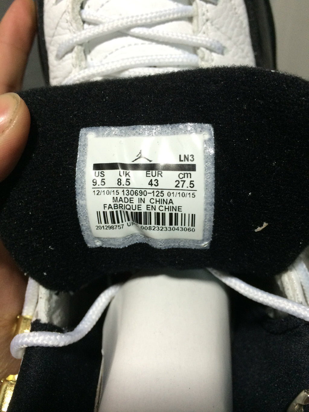 Air Jordan 12 Retro White and Black High-Top Sneakers - product image from the listing.