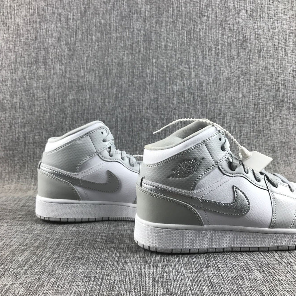 Air Jordan 1 Mid GS White and Silver Sneakers - product image from the listing.