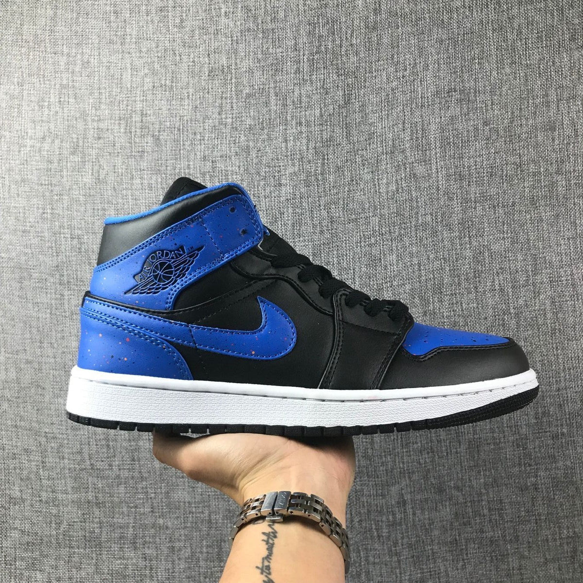 Air Jordan 1 Mid High-Top Sneakers in Black and Blue - product image from the listing.