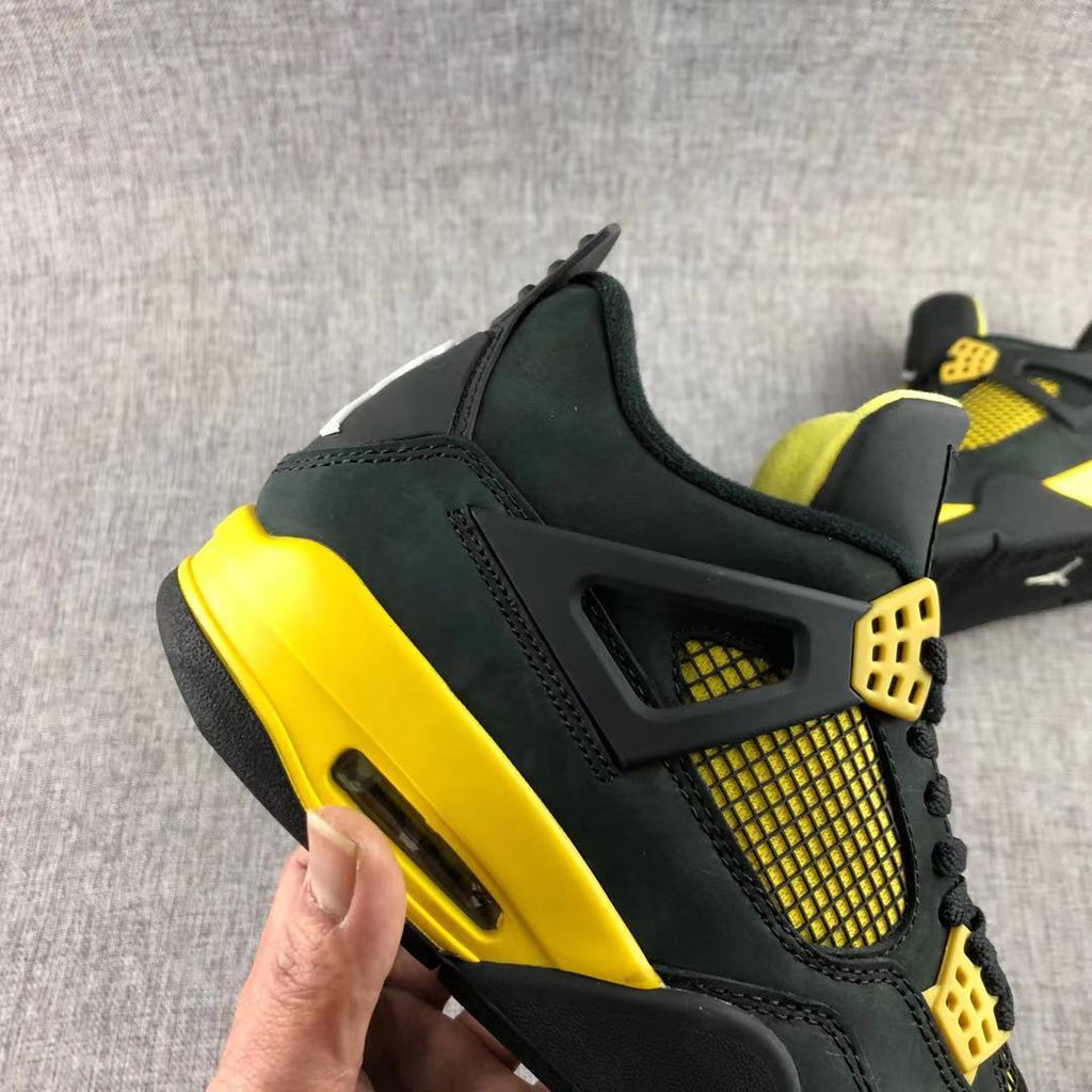Air Jordan 4 Thunder Black Yellow Sneakers - product image from the listing.
