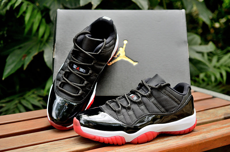 Air Jordan 11 Retro Low Black and Red Sneakers - product image from the listing.