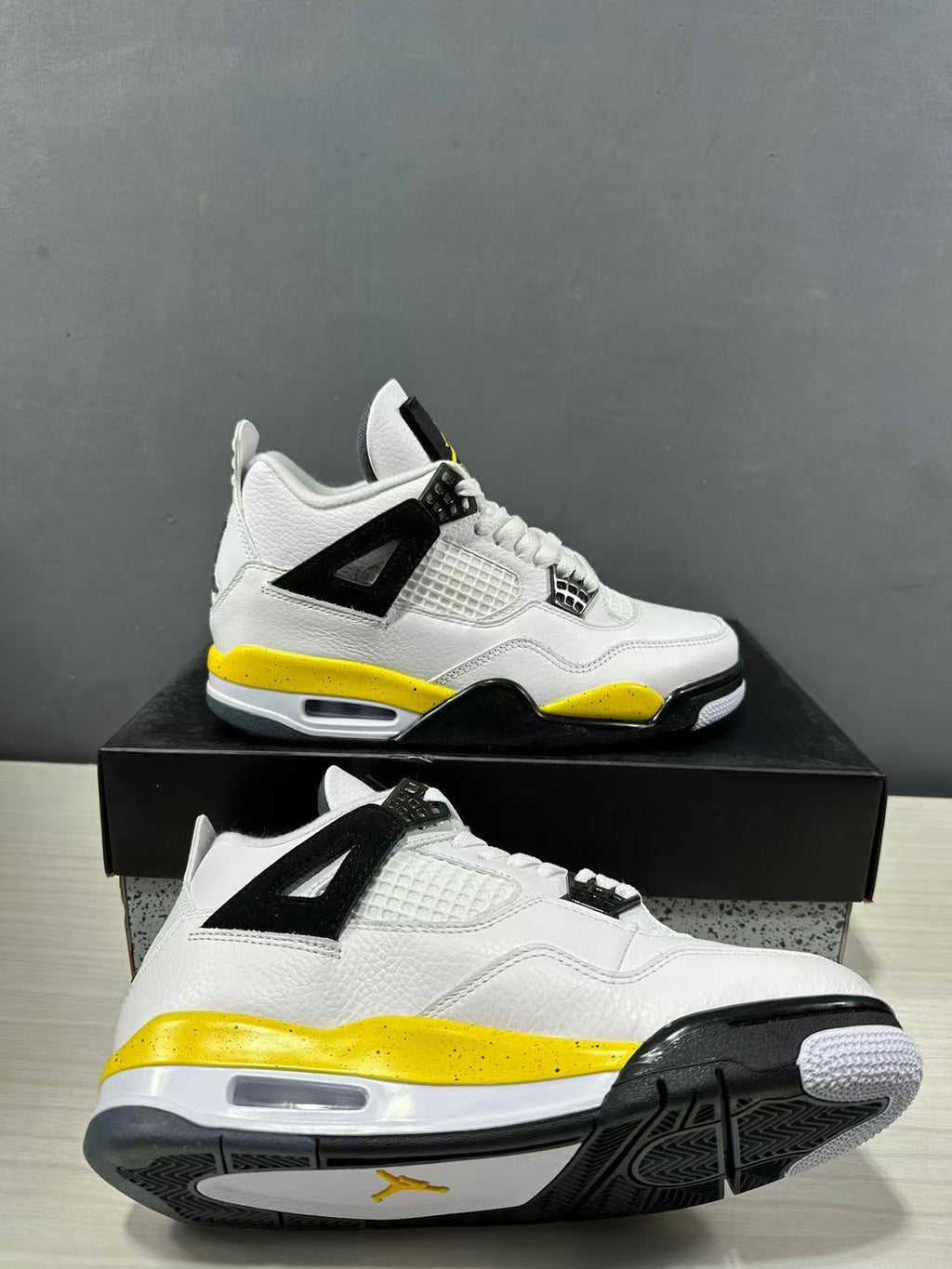 Air Jordan 4 Retro White Yellow Black Sneakers IO2468-102 - product image from the listing.
