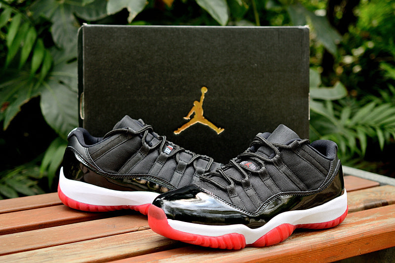 Air Jordan 11 Retro Low Black and Red Sneakers - product image from the listing.