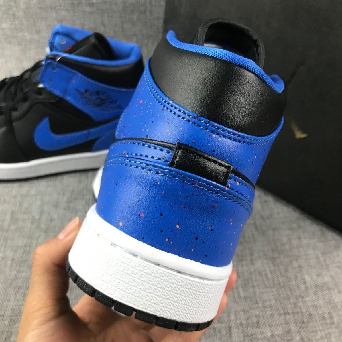 Air Jordan 1 Mid High-Top Sneakers in Black and Blue - product image from the listing.
