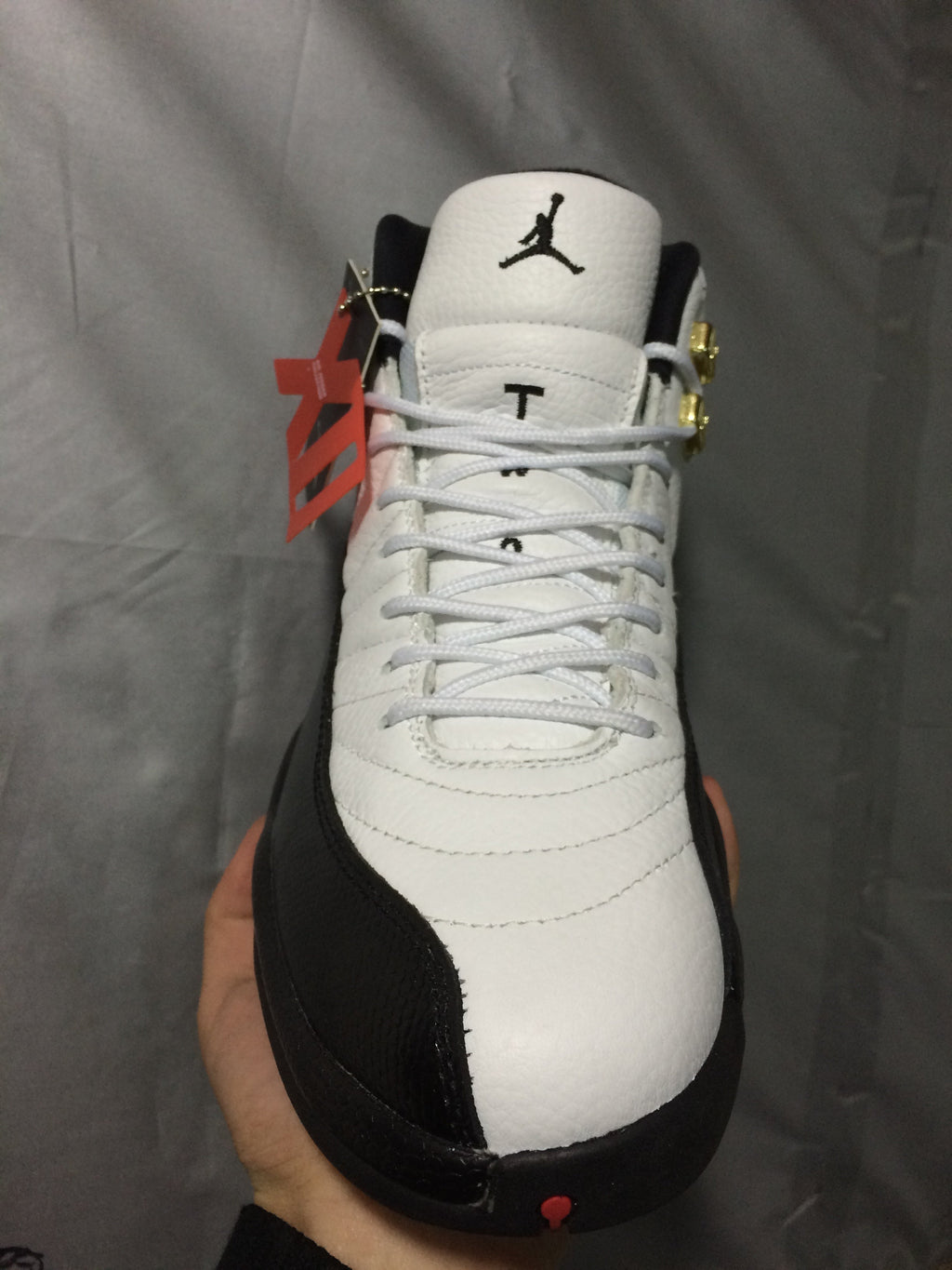 Air Jordan 12 Retro White and Black High-Top Sneakers - product image from the listing.