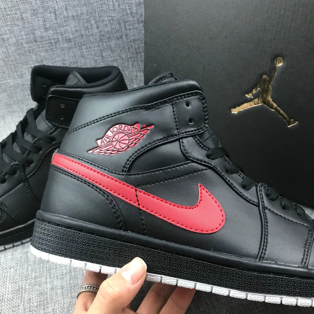 Air Jordan 1 Mid Sneakers in Black and Red 554724-045 - product image from the listing.