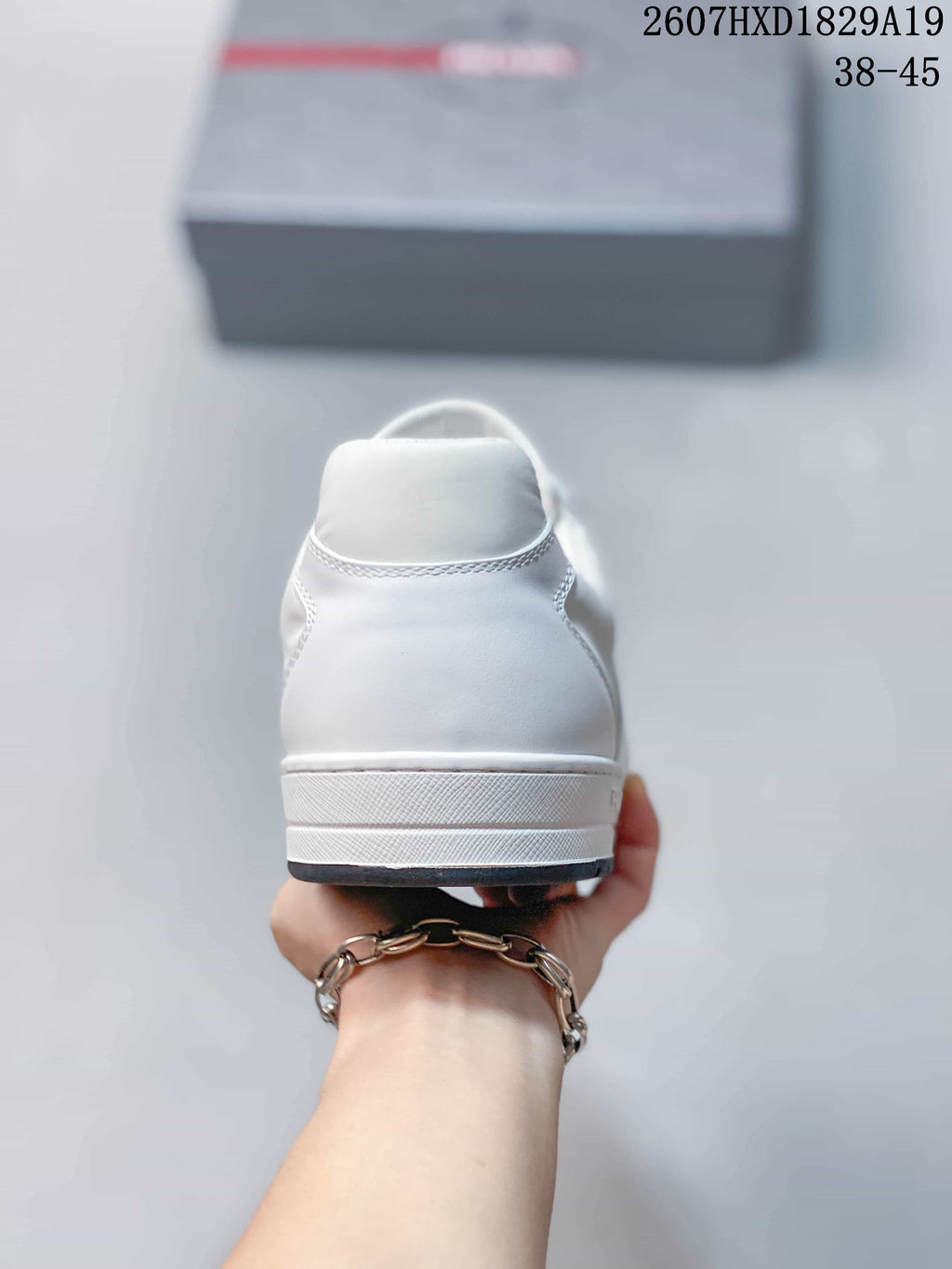Prada Downtown Low-Top Sneakers in White Leather 2607HXD1829A19 - product image from the listing.
