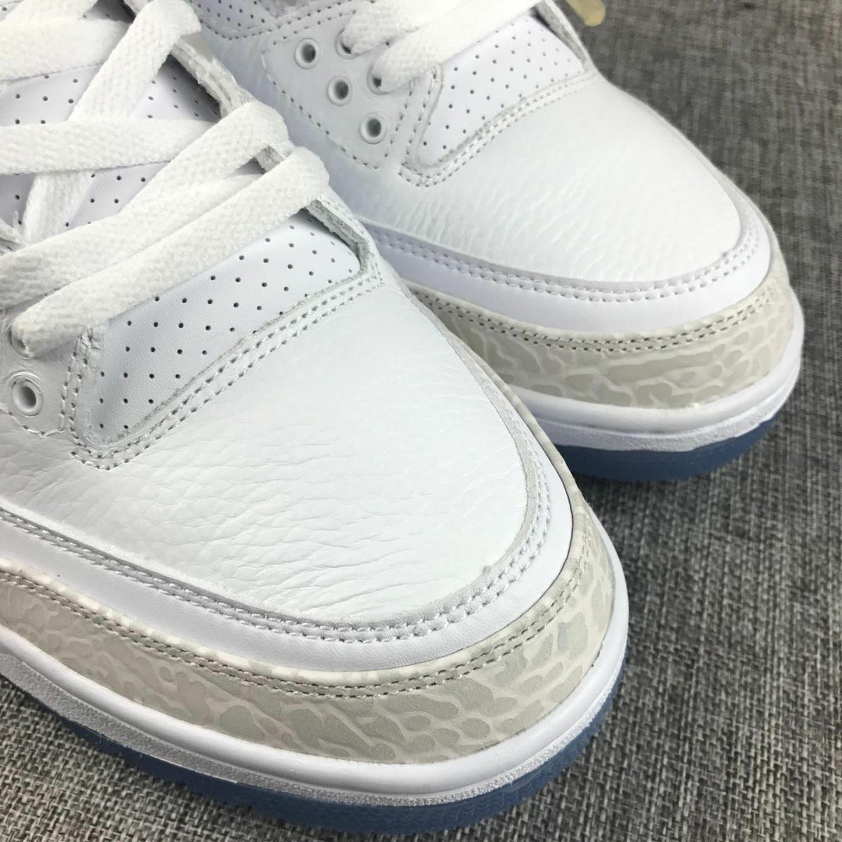 White Cement Sneakers with Blue Translucent Sole - Jordan 3 - product image from the listing.