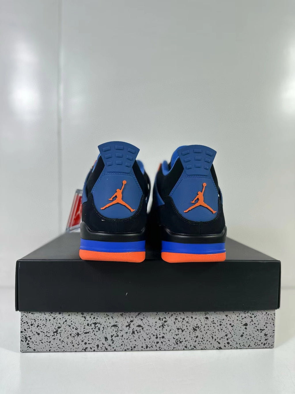 Air Jordan 4 Retro Black Blue Orange Sneakers - product image from the listing.