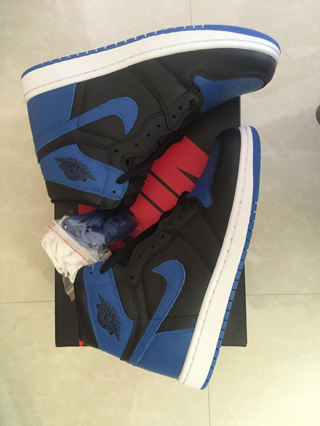 Jordan 1 High Sneakers in Black and Royal Blue - product image from the listing.
