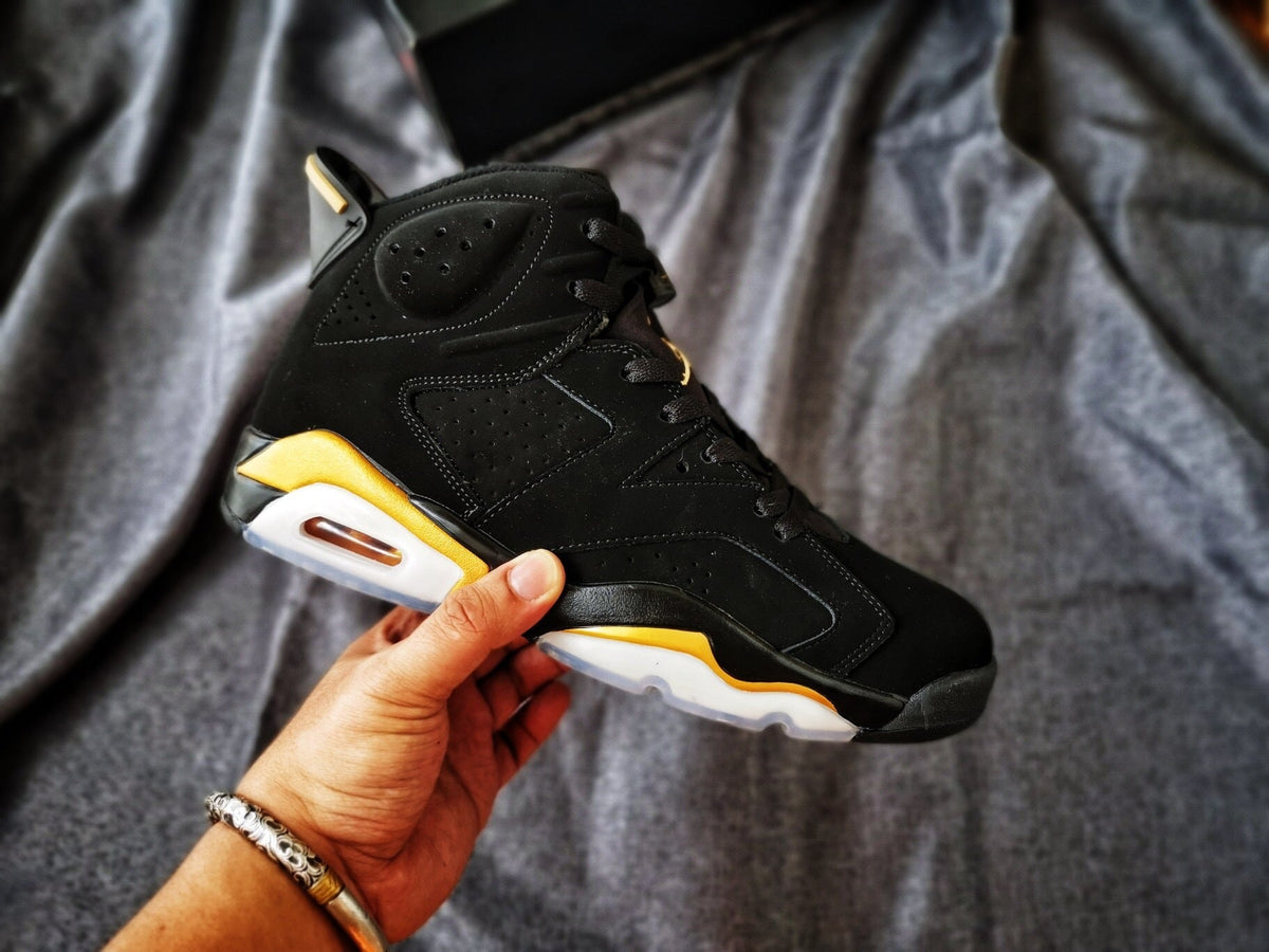 Air Jordan 6 High-Top Sneakers in Black and Gold - product image from the listing.