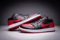 Jordan 1 Low Sneakers in Black and Red - product image from the listing.