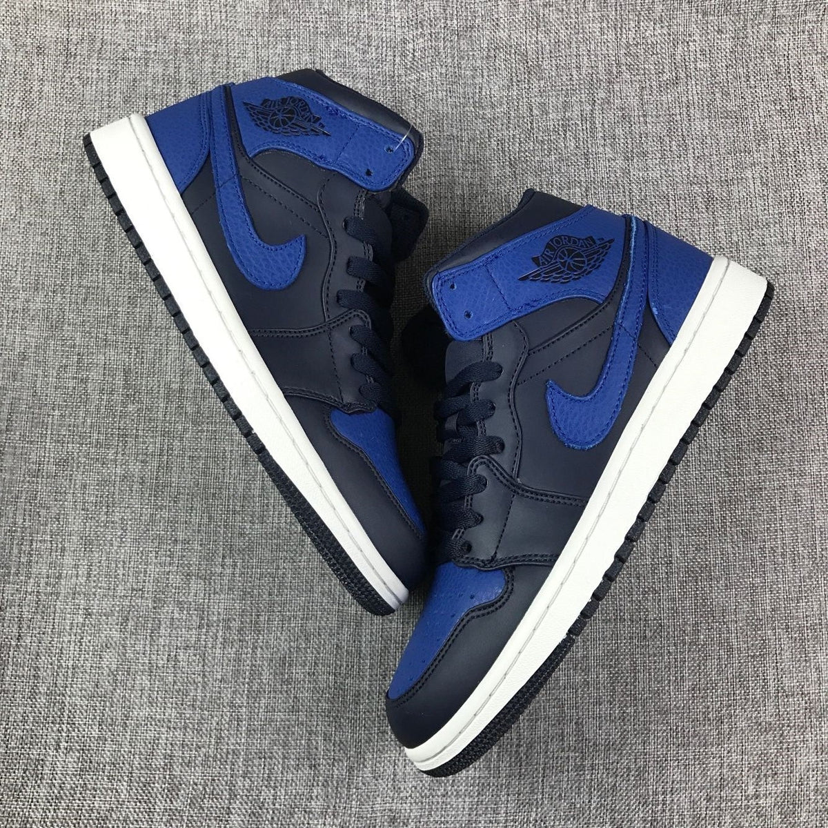 Air Jordan 1 Mid High-Top Sneakers in Black and Royal Blue - product image from the listing.