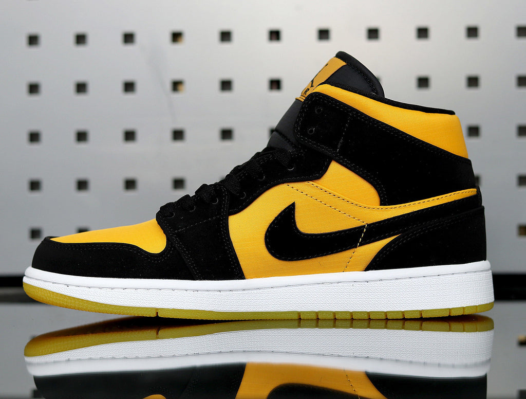 Jordan 1 High Sneakers in Yellow and Black - product image from the listing.