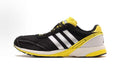 JP7635 Black and Yellow Three-Stripe Shoes for Running - product image from the listing.