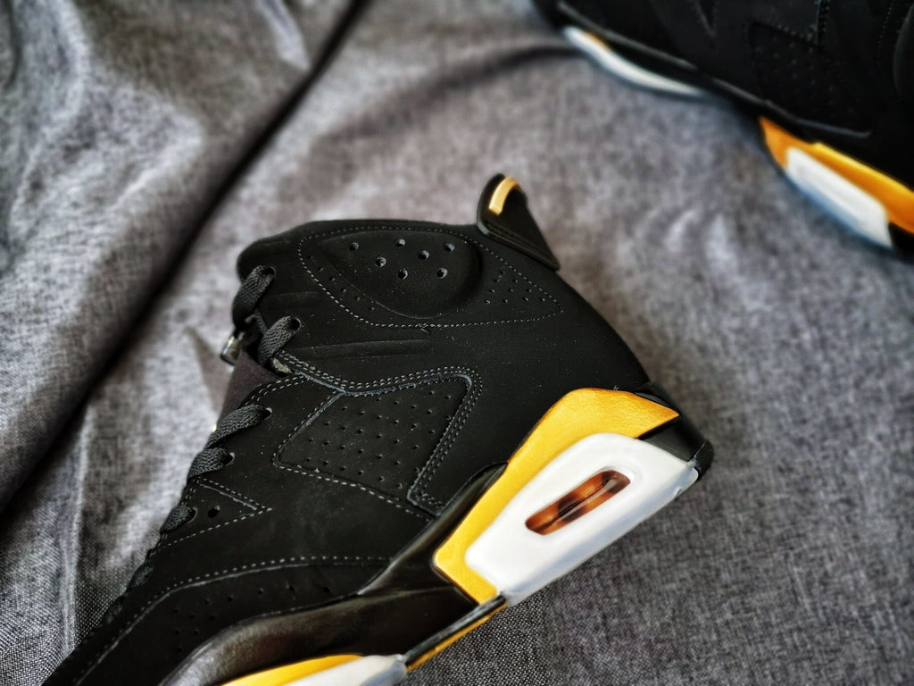 Air Jordan 6 High-Top Sneakers in Black and Gold - product image from the listing.