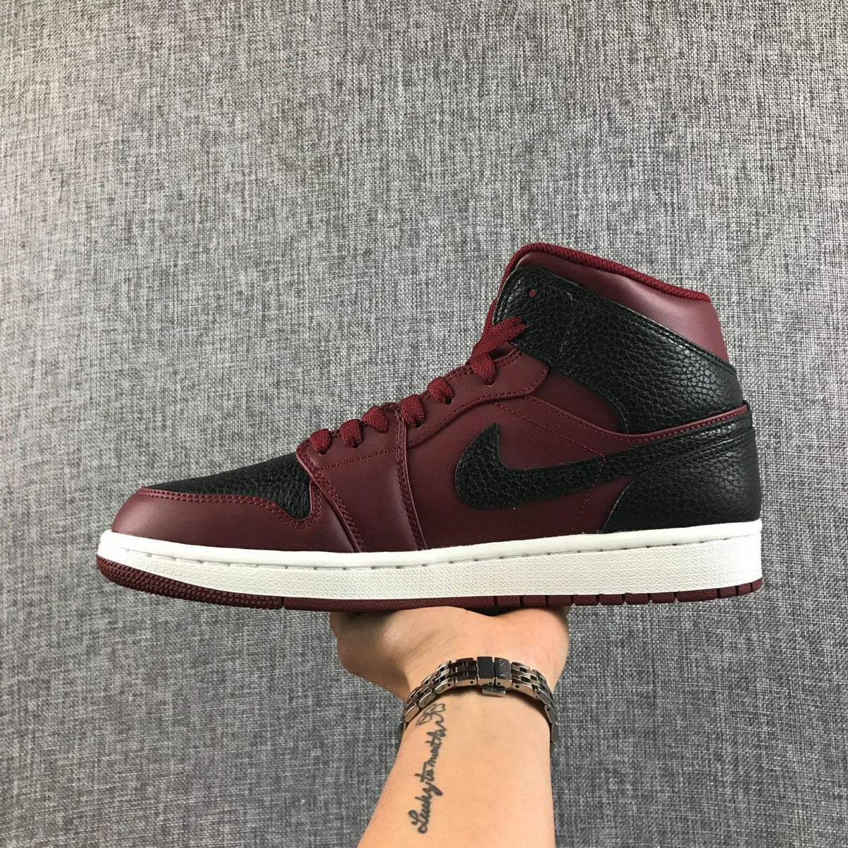Air Jordan 1 Mid Sneakers in Black and Burgundy 554724-601 - product image from the listing.