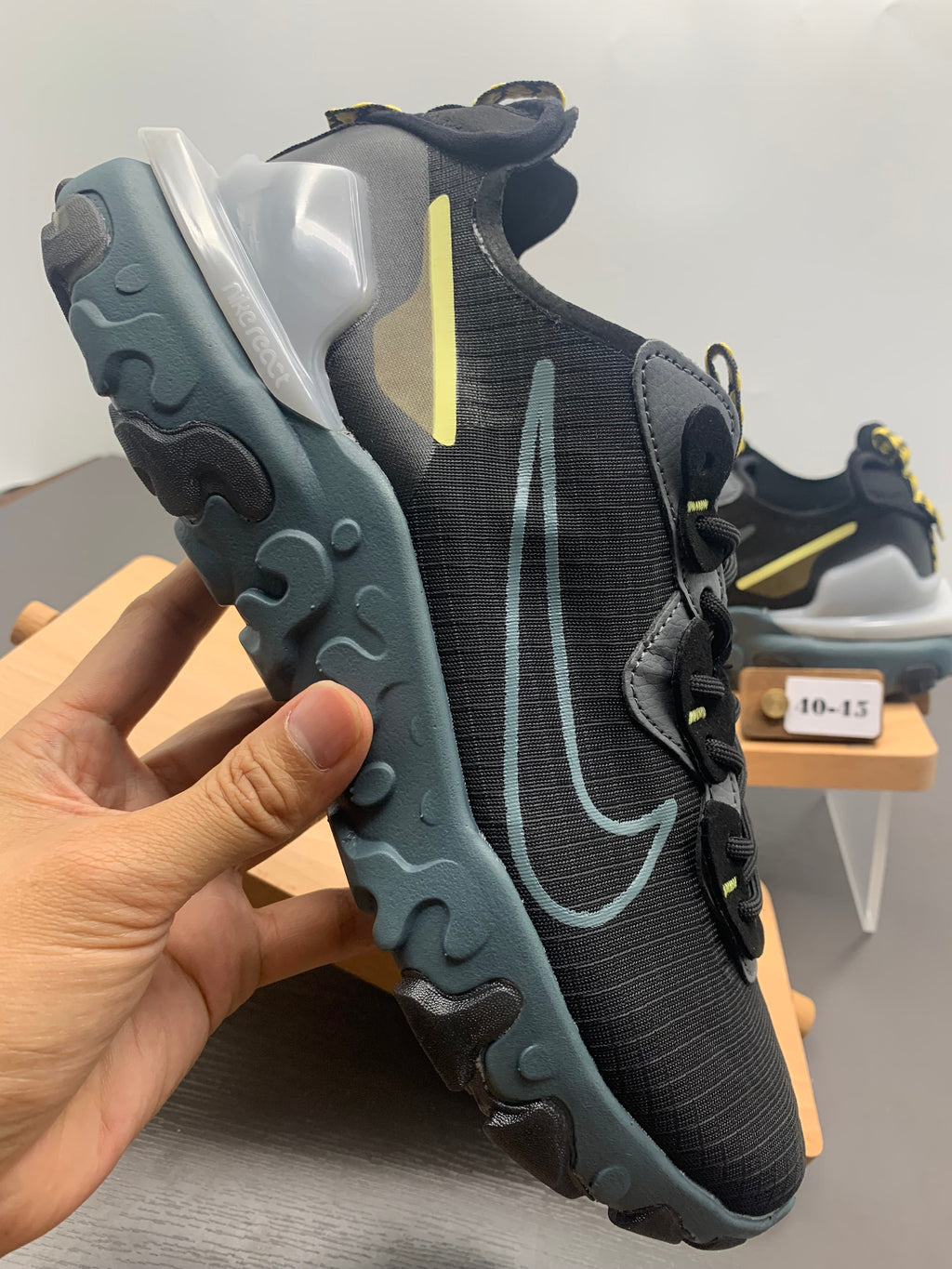 Nike React Black and Grey Trainers with Blue Accents - product image from the listing.