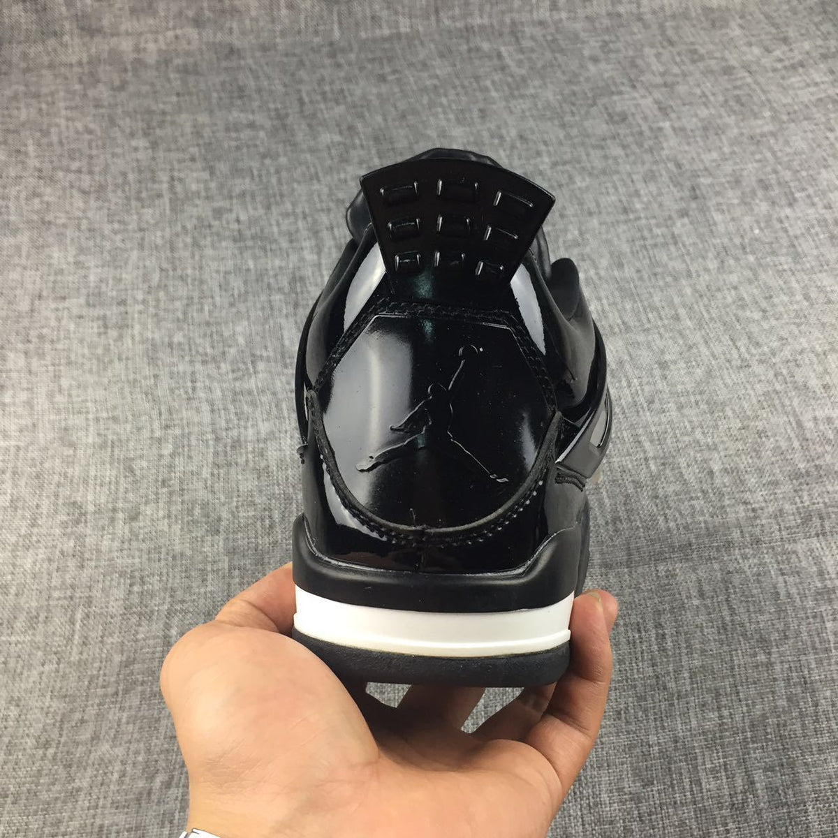 Air Jordan 4 Black Glossy Sneakers - product image from the listing.