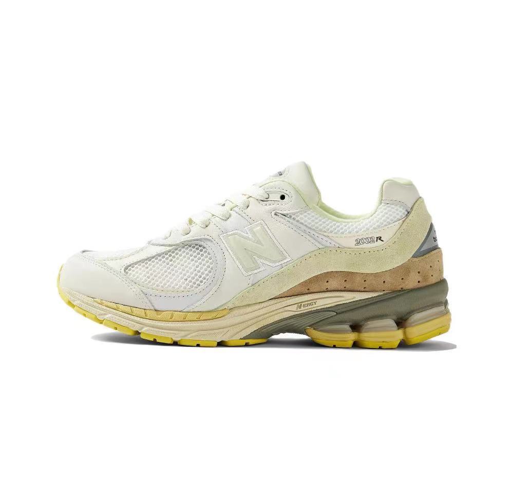 White and Yellow New Balance 2002R Sneakers - product image from the listing.