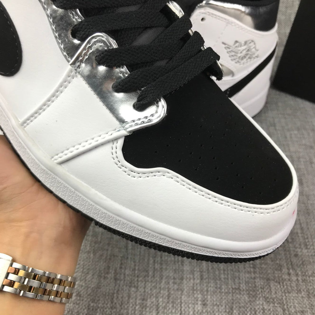 Air Jordan 1 Mid Sneakers in White and Black - product image from the listing.