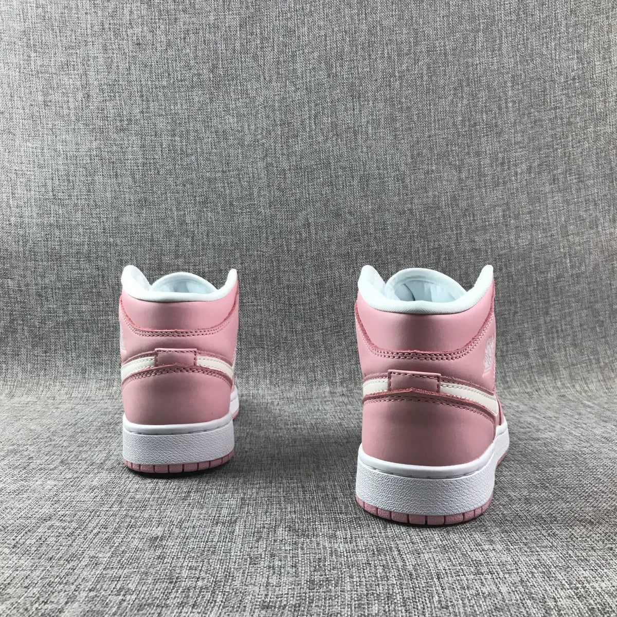 Women's Jordan 1 Mid Pink Sneakers 555112-100 - product image from the listing.