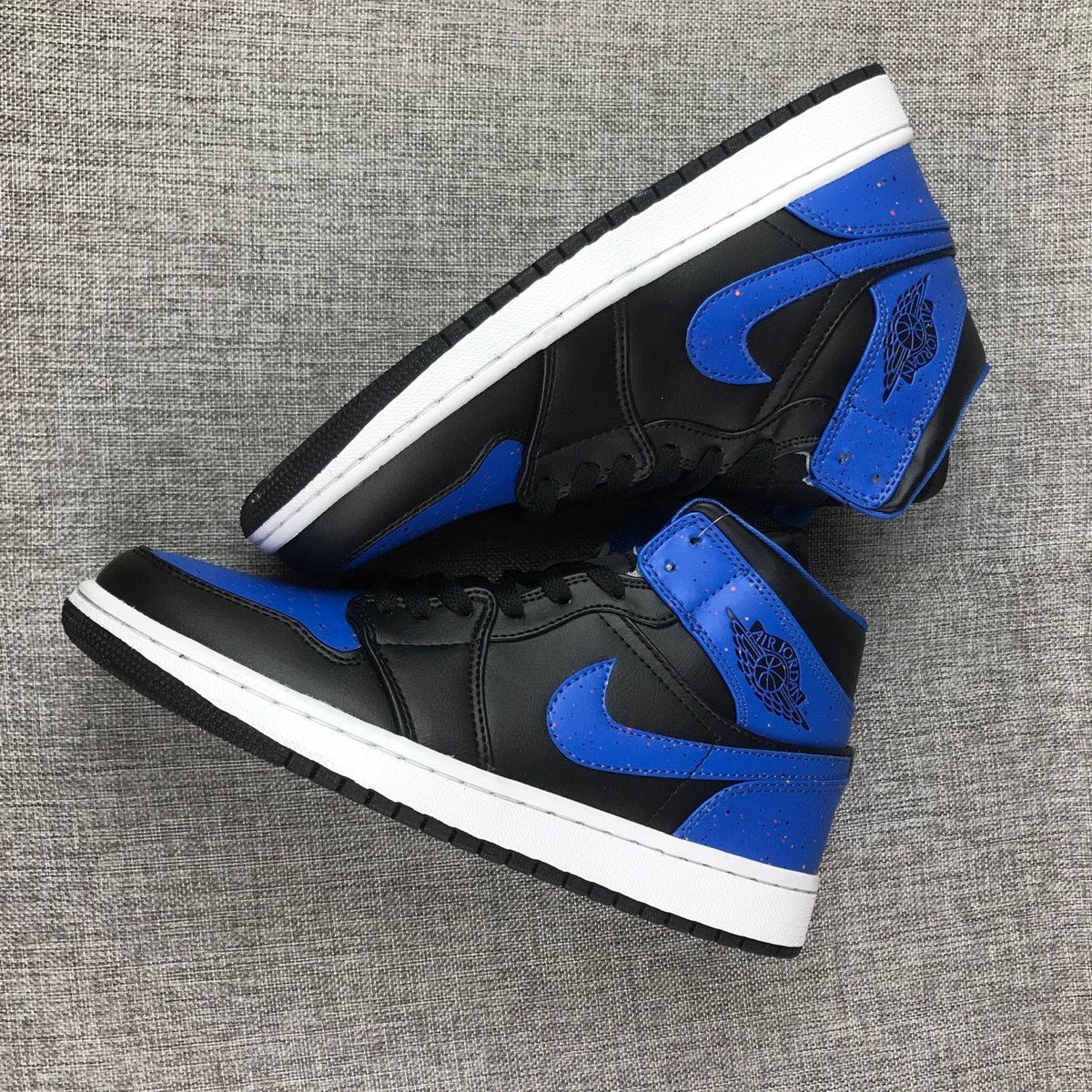 Air Jordan 1 Mid High-Top Sneakers in Black and Blue - product image from the listing.