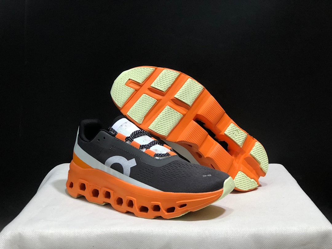 On Cloudmonster Running Shoes in Black Orange - product image from the listing.