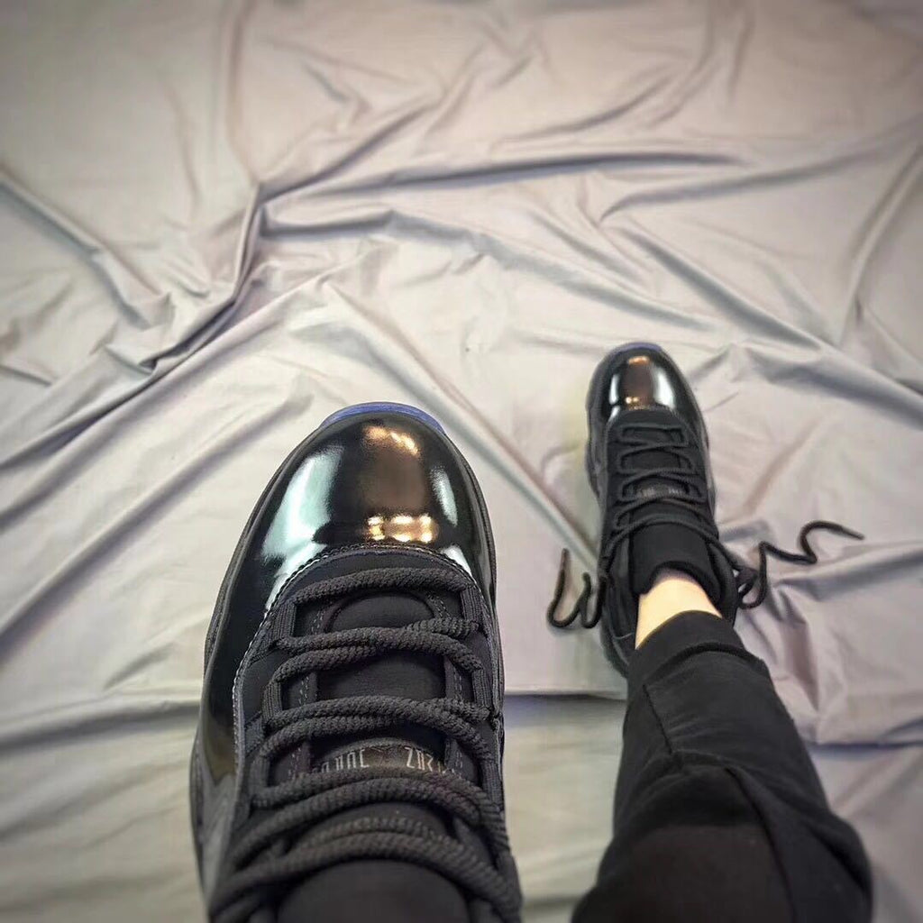 Air Jordan 11 Cap and Gown High-Top Sneakers in Black - product image from the listing.