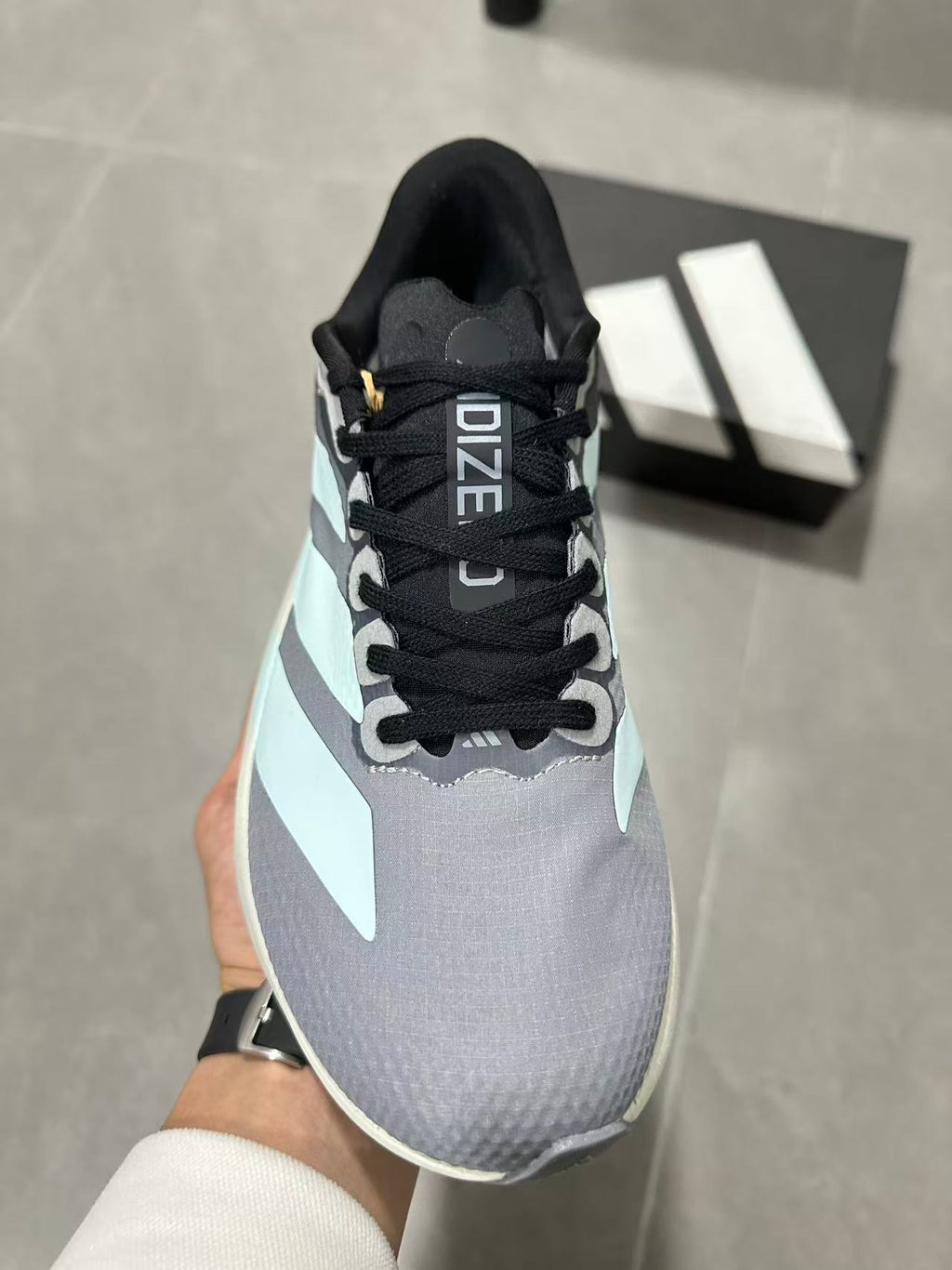 Gray and Blue Adidas Lightstrike Pro Running Shoes - product image from the listing.