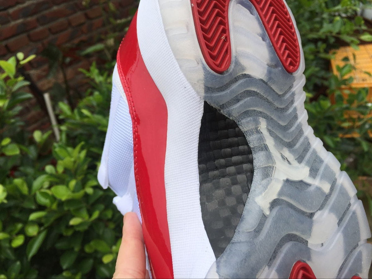 Air Jordan 11 Low Sneakers White Red - product image from the listing.