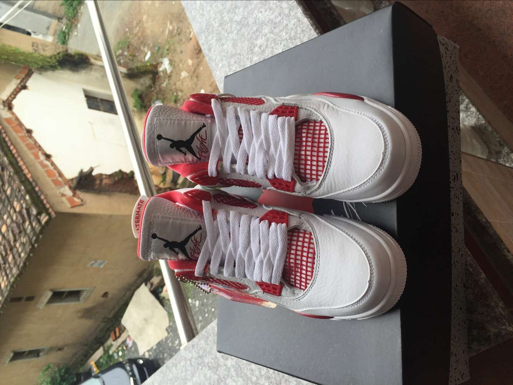 Jordan 4 Retro High-Top Sneakers in White and Red - product image from the listing.