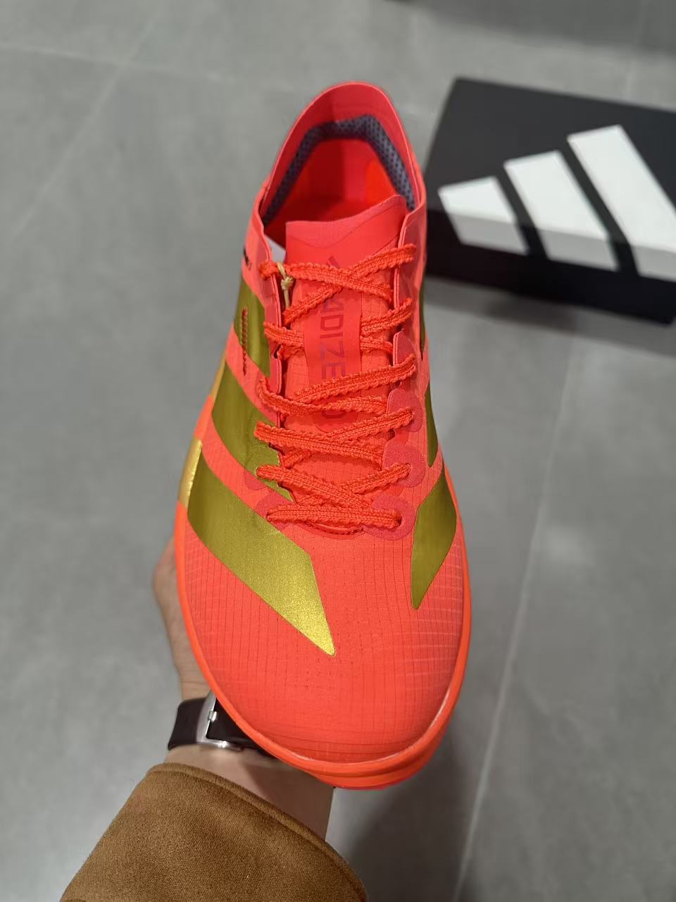 Adidas Adizero Adios Pro 5 Running Shoes, in Red and Lime - product image from the listing.