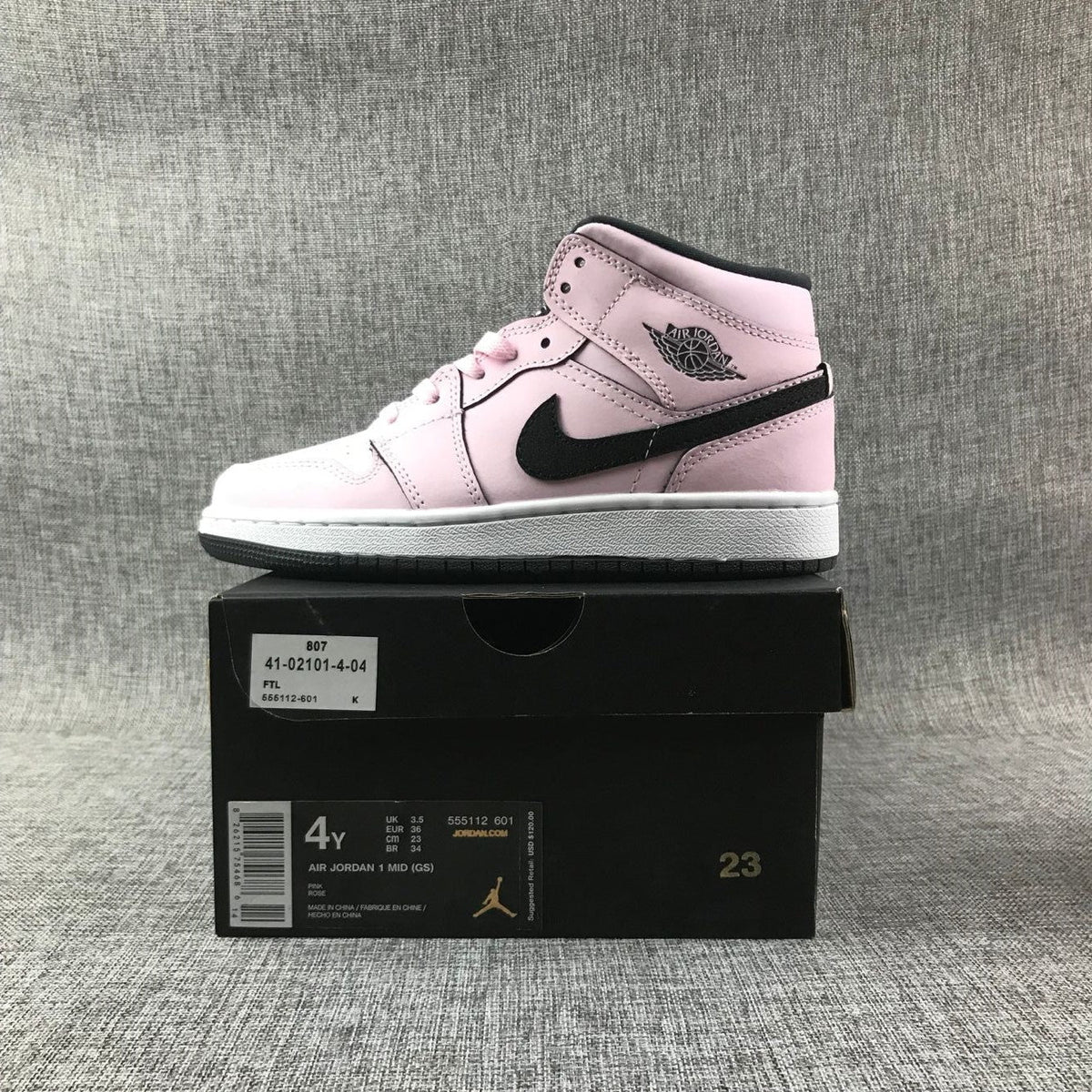 Air Jordan 1 Mid High-Top Sneakers in Pink and Black - product image from the listing.