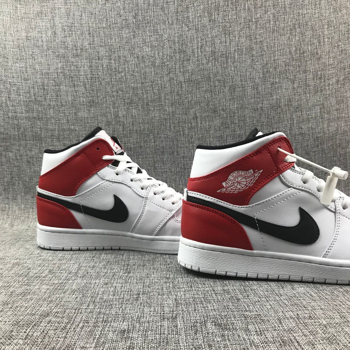 Air Jordan 1 Mid Sneakers in White Red 554724-116 - product image from the listing.